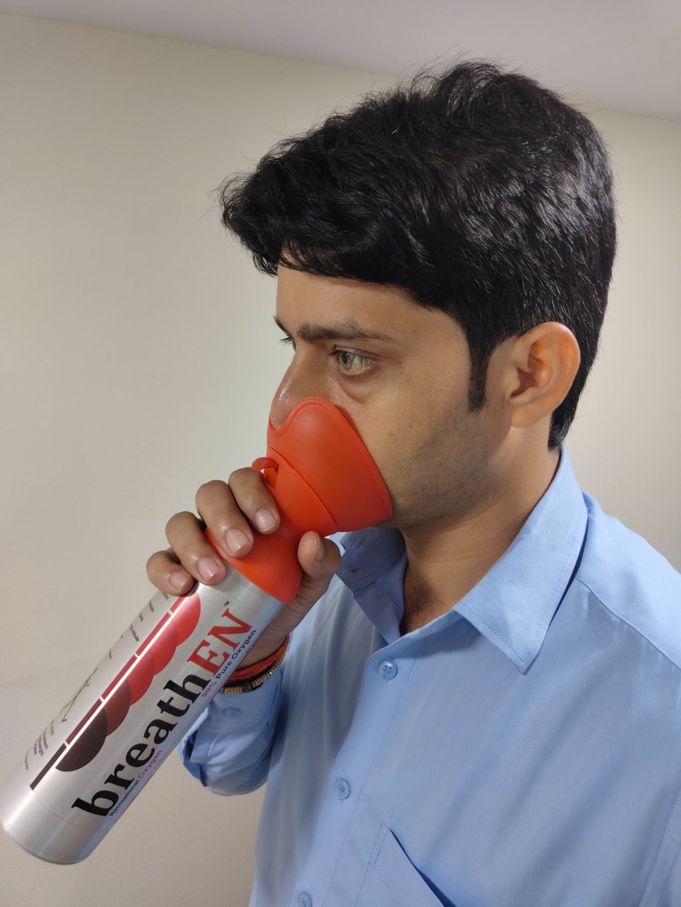 Person using breathEN oxygen canister